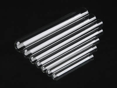 Seven glass test tubes in different sizes on the black background.