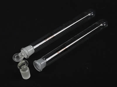A closed and an opened glass test tube with quartz stopper on the black background.