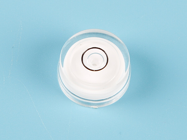 A plastic circular tubular bubble level vial