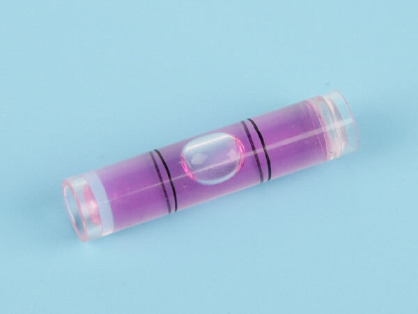 A purple plastic tubular bubble level vial