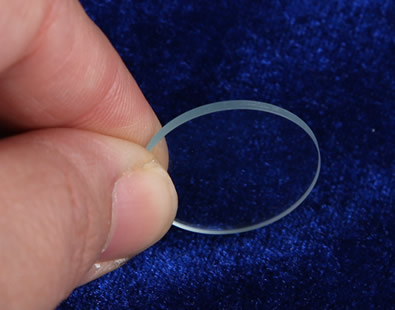 One piece of glass disc stands on the ground.