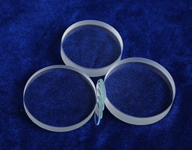 Five pieces of polished surface glass discs are on the desk.