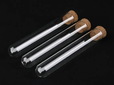Three glass test tubes with cork stoppers and round bottom on the black background.